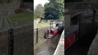 Silsden hire boat departs the locks at Gargrave heading towards Skipton on the Leeds Liverpool canal [upl. by Rehportsirhc]