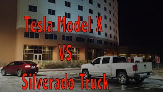 Model X Towing a Chevy Silverado Truck out of a Supercharger Station [upl. by Harret31]