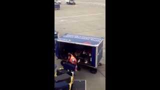 Delta Airlines baggage handler throwing bags into the cart in Seattle Delta [upl. by Libbna]