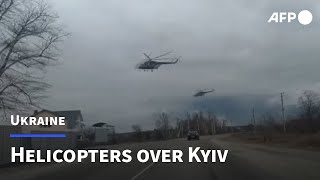 Helicopters seen flying low over Kyiv near Gostomel airbase  AFP [upl. by Milman]